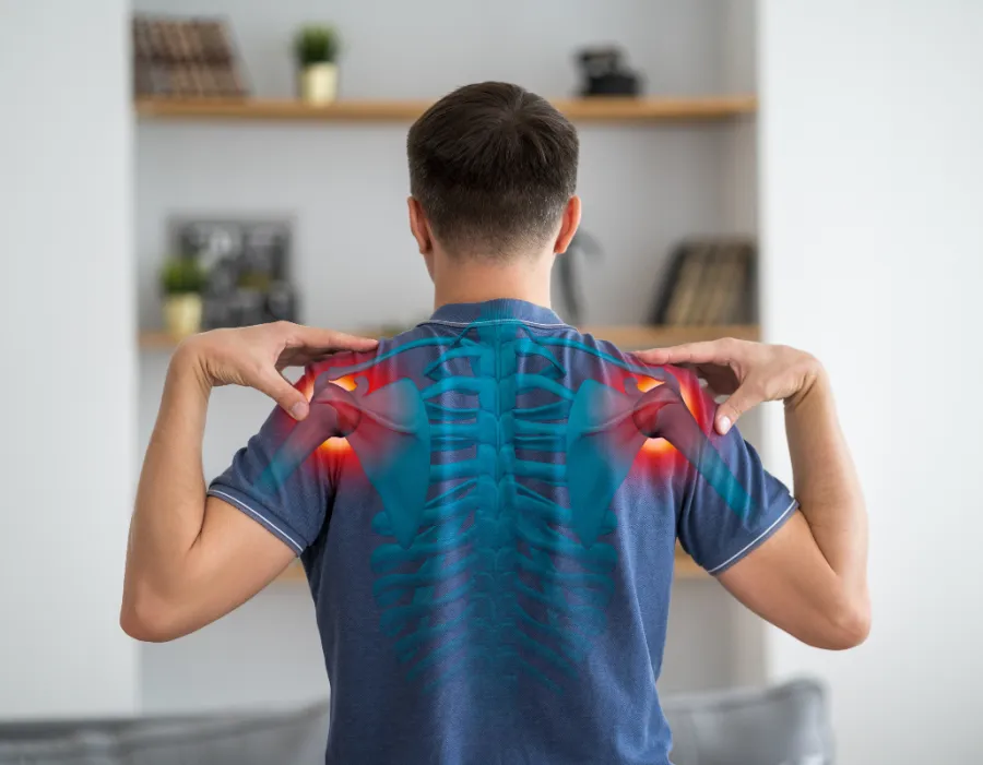 Man holding his upper back and shoulders with inflamed areas highlighted, illustrating chronic pain and inflammation